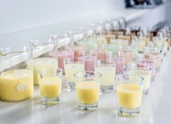 rows of shot glasses with colourful creamy liquid