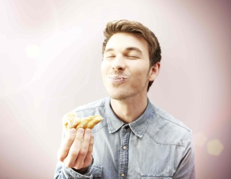 a man heating a doughnut.