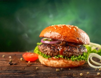 A hearty hamburger with lettuce and tomatoes.