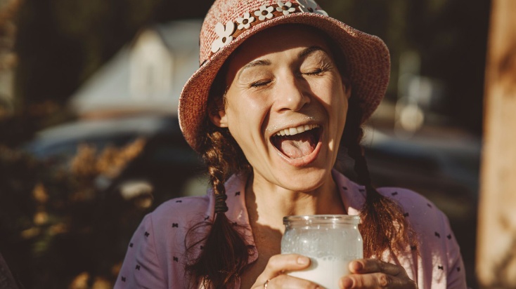 Woman enjoying a drink of fresh milk