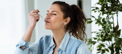 A woman enjoying a natural yoghurt